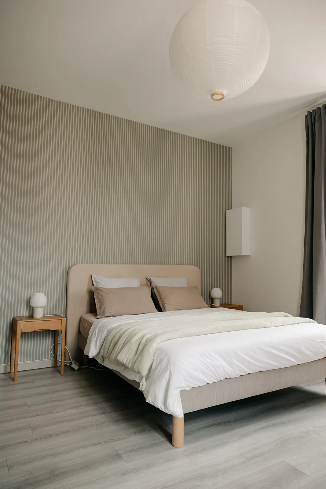 Queen-size bed with white linen and a sea-green throw